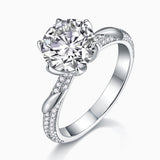 Twisted pavé moissanite ring with round center stone; split shank covered in small stones