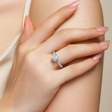 Round moissanite pave wedding ring on hand, white metal band and prong-set center