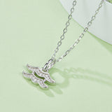 Aquarius pendant necklace, side view of wave glyph with sparkling stones on silver links