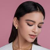 Bezel moissanite ball stud earrings in yellow gold vermeil, worn on ear (side view)