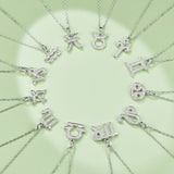 Assorted zodiac pendant necklaces on link chains, Taurus charm highlighted in white gold vermeil