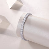 Princess cut moissanite tennis bracelet close-up, silver-toned link setting with square stones