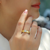 Yellow gold vermeil solitaire ring with square moissanite stone, worn on hand