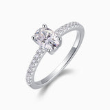 Oval-cut moissanite engagement ring, pavé side stones and polished metal band