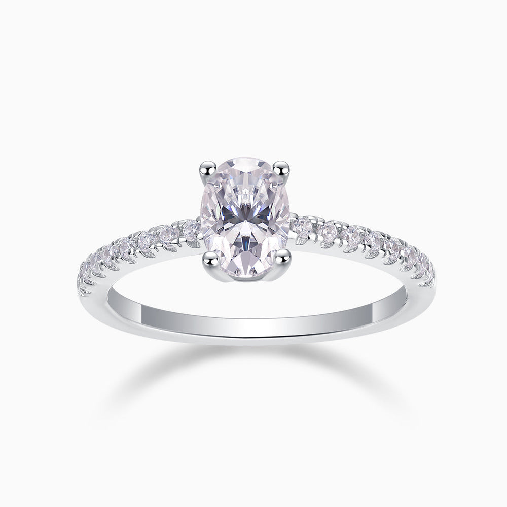 Oval-cut pavé moissanite engagement ring with split prong setting, sparkling stones on band
