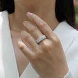 White gold vermeil triple-row eternity band on hand, round moissanite stones