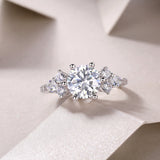 Round moissanite pavé ring with central round stone and small side stones, white gold