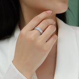 Three-row eternity ring with pavé stones on finger, white gold vermeil