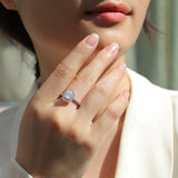 Pear-cut halo ring on hand, white gold vermeil band with pavé sparkle