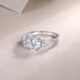 Three-stone moissanite ring, white gold-plated band with pavé detail on the shoulders
