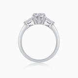 Three-stone moissanite ring top view from behind, prongs around heart-cut center stone
