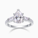 Pear-cut moissanite with baguette side stones and pavé band, white gold ring profile