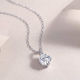 Close-up: round moissanite solitaire pendant on white gold vermeil chain