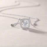 Cushion halo moissanite pendant close-up on station chain, white gold vermeil