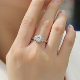 Round halo art deco cross pavé ring on finger, detailed halo and pavé band