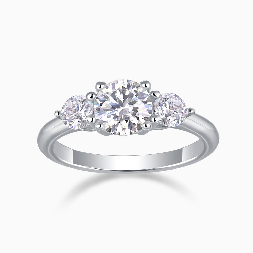 Three-stone round moissanite engagement ring in white gold vermeil with center and side stones