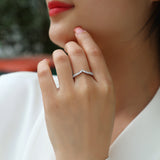 Curved Moissanite Pavé Band on finger, white gold vermeil with bright round pavé stones