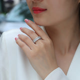 Moissanite half eternity ring on a hand, triple row of round stones