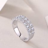 Double-row moissanite half pavé band ring close-up, showing raised square-set stones