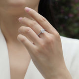 Engagement ring on finger: emerald-cut center stone with pavé detail, white gold vermeil