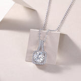 Cushion halo moissanite pendant with prong-set center stone and pavé border, white gold