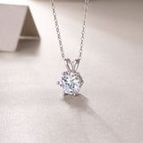 Close-up of round moissanite pendant with 6-prong crown setting, white gold vermeil