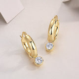 Chunky hoop earrings with bezel-set round moissanite drops, yellow gold vermeil