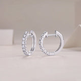 Moissanite huggie hoop earrings in shared prong setting, side view with hinge post