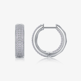 Moissanite huggie hoops in white gold vermeil with pavé stones, front view.