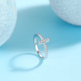 Thin cross band ring, profile view with moissanite pavé cross on metal shank