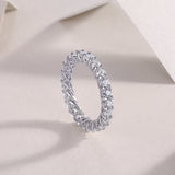 Moissanite eternity band with round stones and sculpted basket settings, white gold vermeil