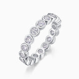 White gold vermeil eternity band with alternating round moissanite settings