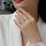 Moissanite pavé eternity band ring on hand, continuous sparkling stone row