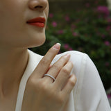 Moissanite pavé eternity band on finger, white-gold look with round stone sparkle row