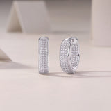 Moissanite huggie hoops, white gold vermeil, pavé stones with hinge detail, side view.