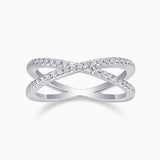 X-Cross Moissanite pavé band ring with X-shaped crossover and clear stones on white metal