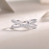X-Cross Moissanite pavé band with X design and sparkling clear stones on white metal