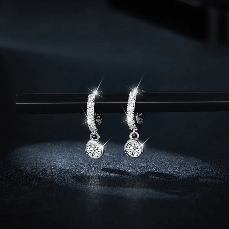 Round moissanite dangle earrings in pavé huggie bezel with dangling solitaire