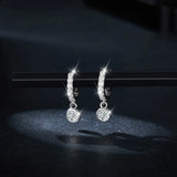 Round moissanite dangle earrings in pavé huggie bezel with dangling solitaire