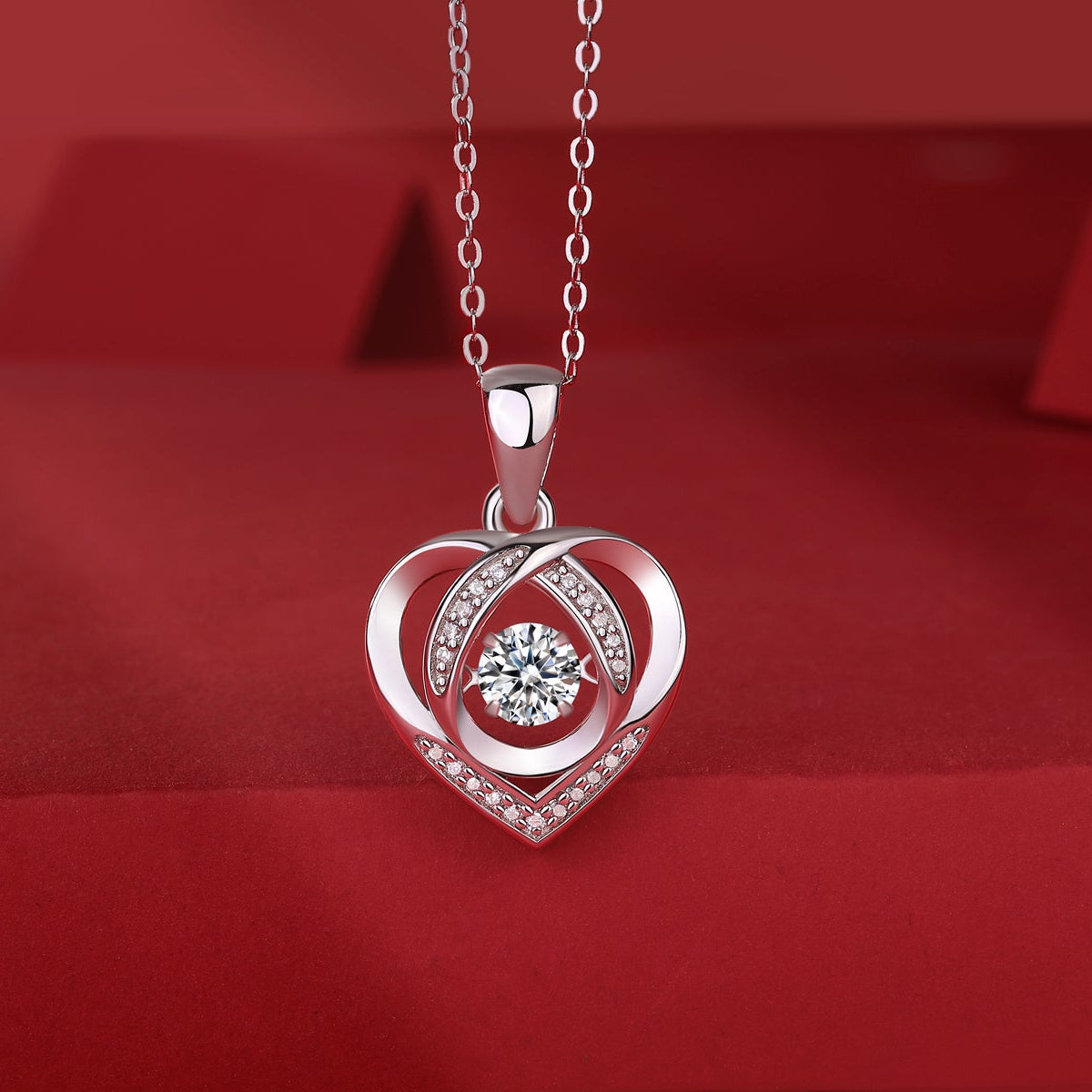 Heart moissanite pendant with round center stone and pavé border on link chain