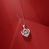 Close-up heart pendant with round moissanite center and pavé edges on chain