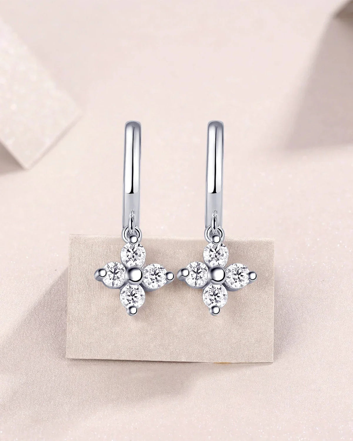 Four-petal flower moissanite drop huggie earrings with round side stones, silver-tone