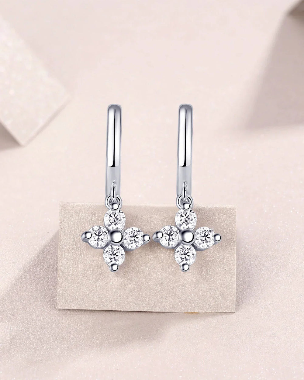 Four-petal flower moissanite drop huggie earrings with round side stones, silver-tone