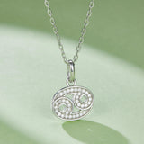Oval Cancer pendant necklace with green accent stones and pave border on chain