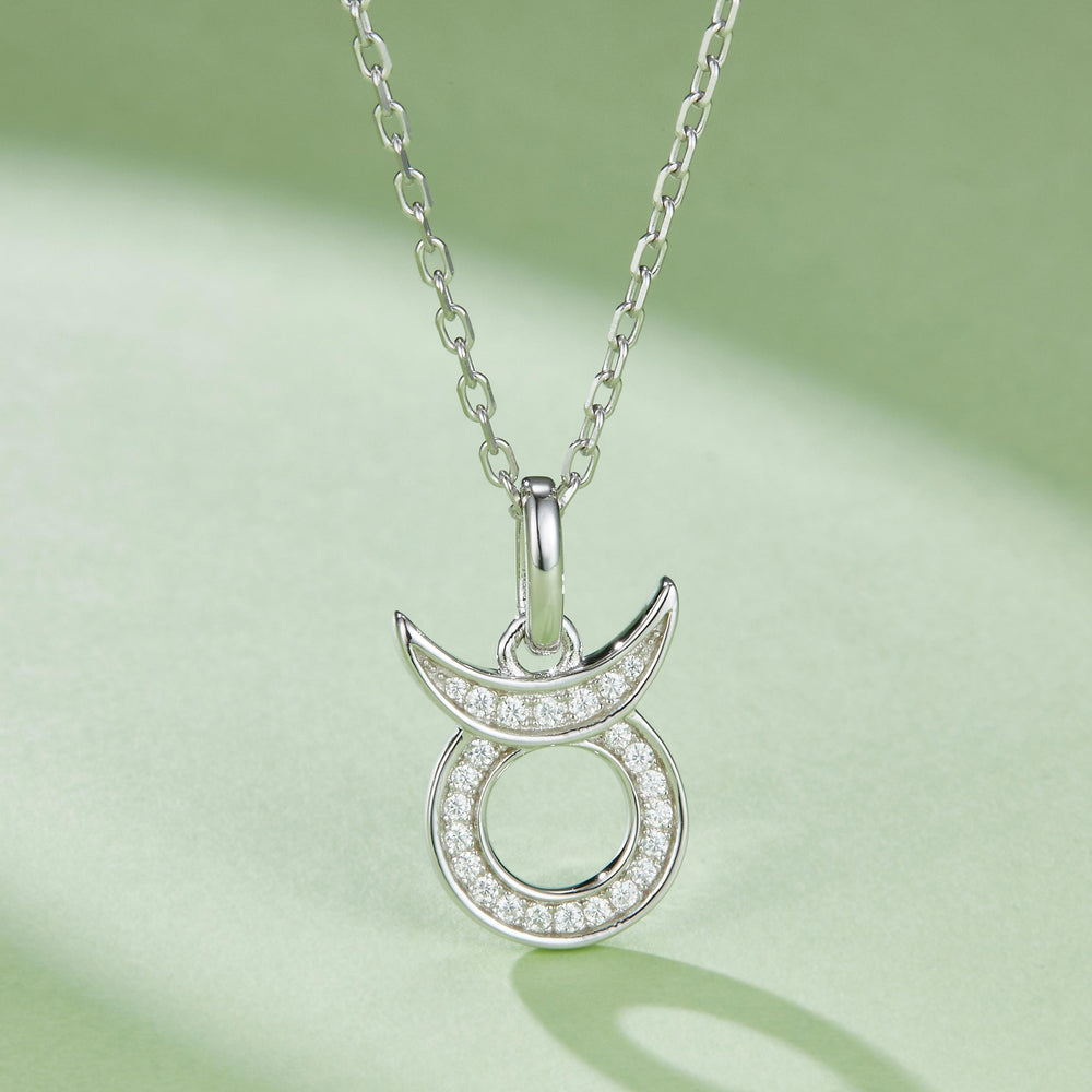Taurus moissanite pendant with curved horns, pavé stones, hanging from link chain