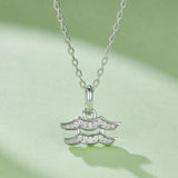 Aquarius zodiac pendant with stacked wave design and round-cut stones, on silver chain