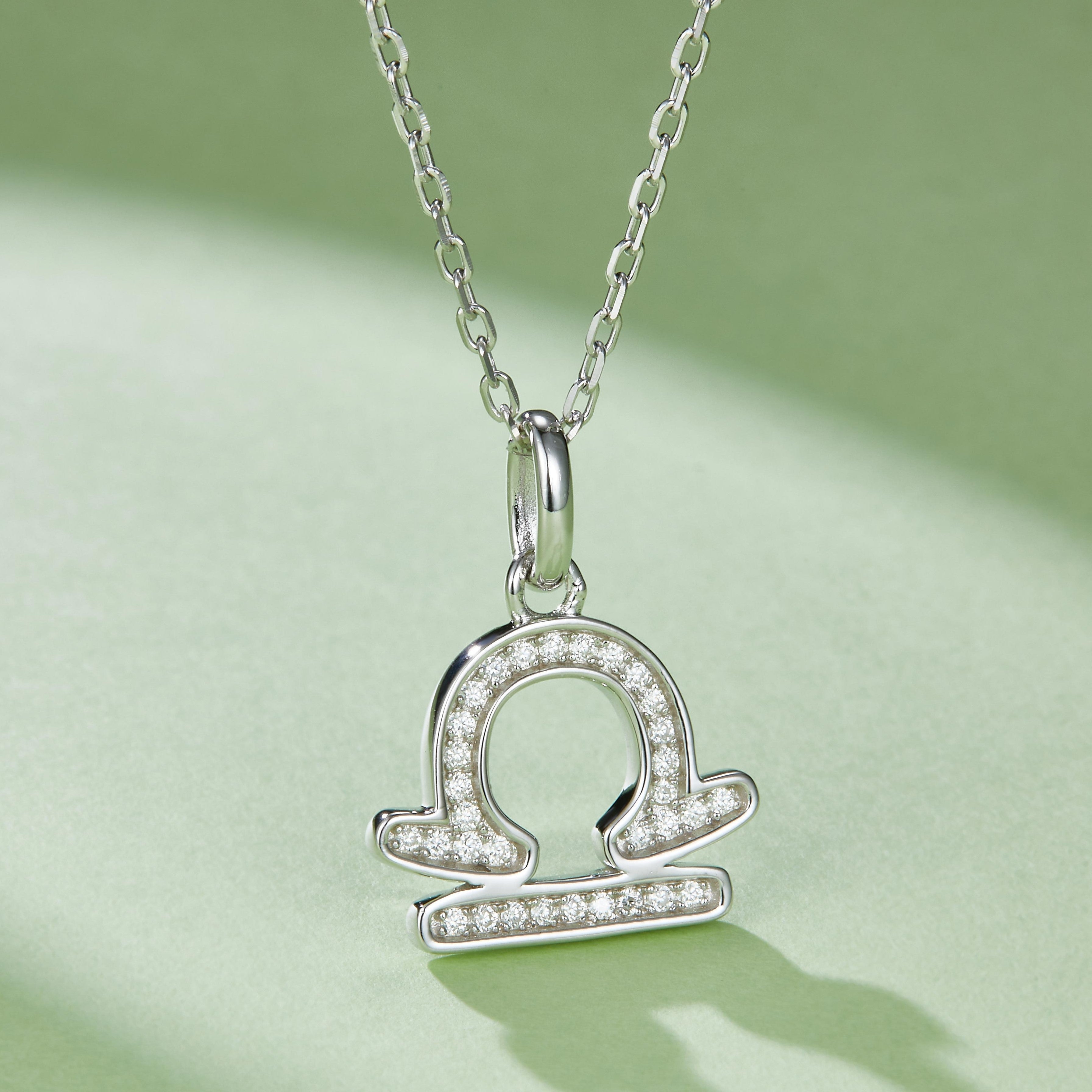 Libra zodiac pendant necklace with circular center and halo of small stones