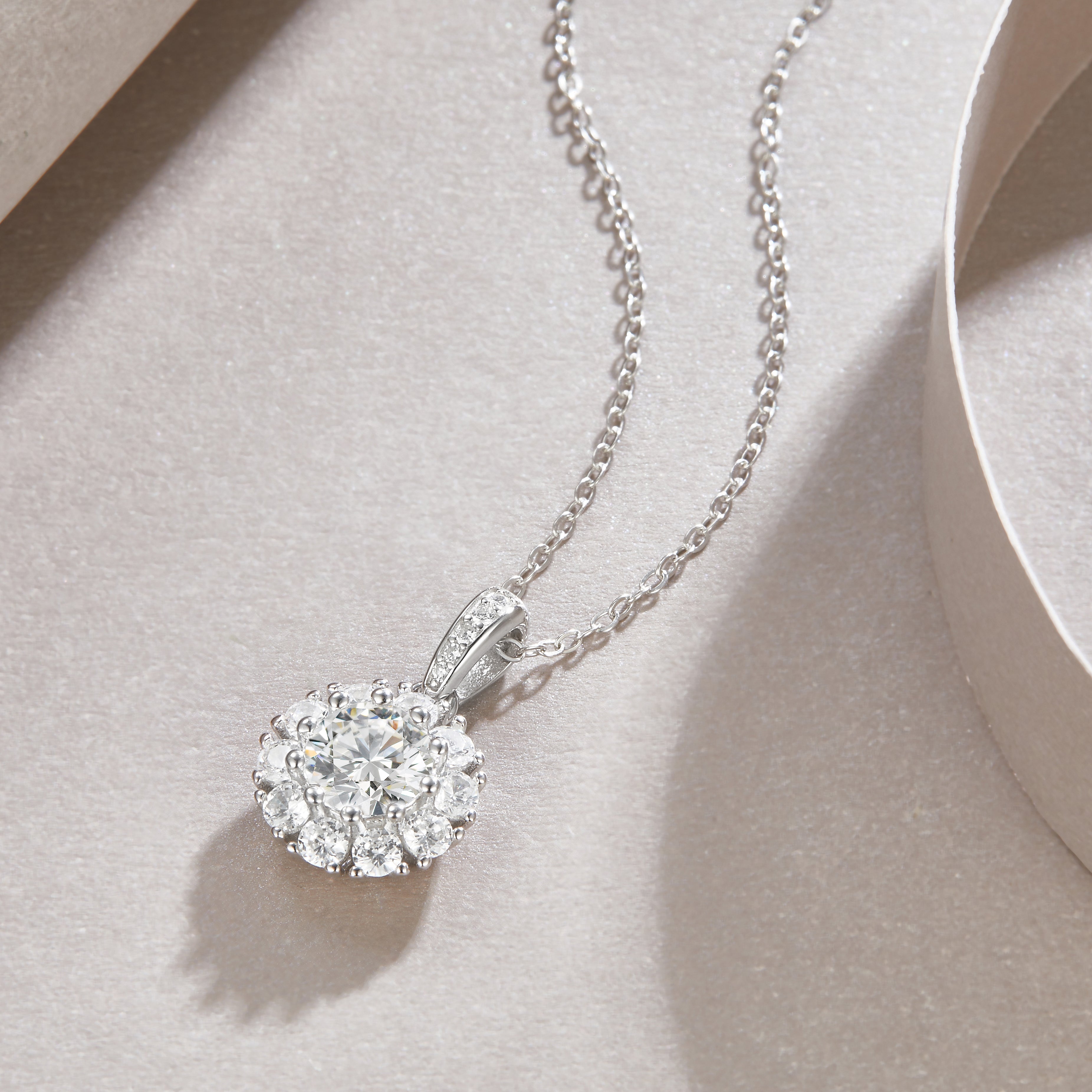 Round halo moissanite pendant with prong-set stones and linked chain