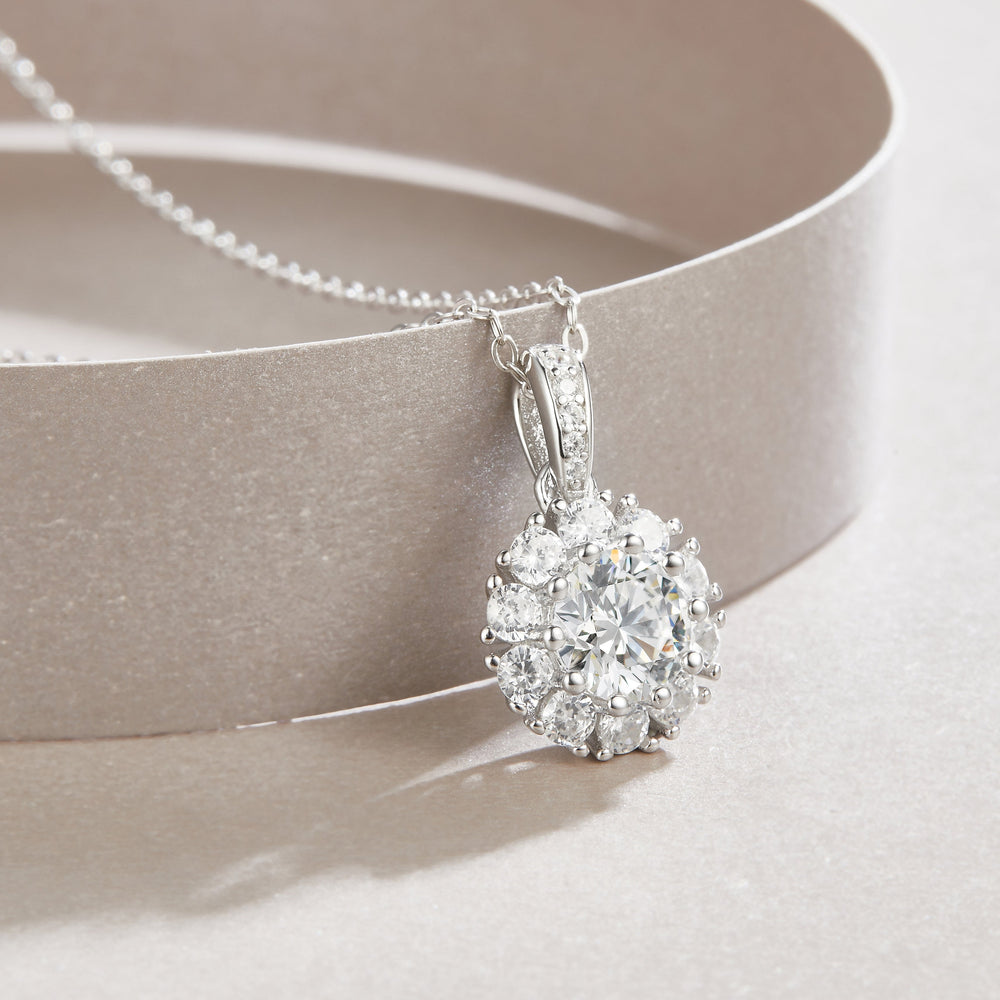 Close-up halo pendant with round center stone and sparkling ring of small stones