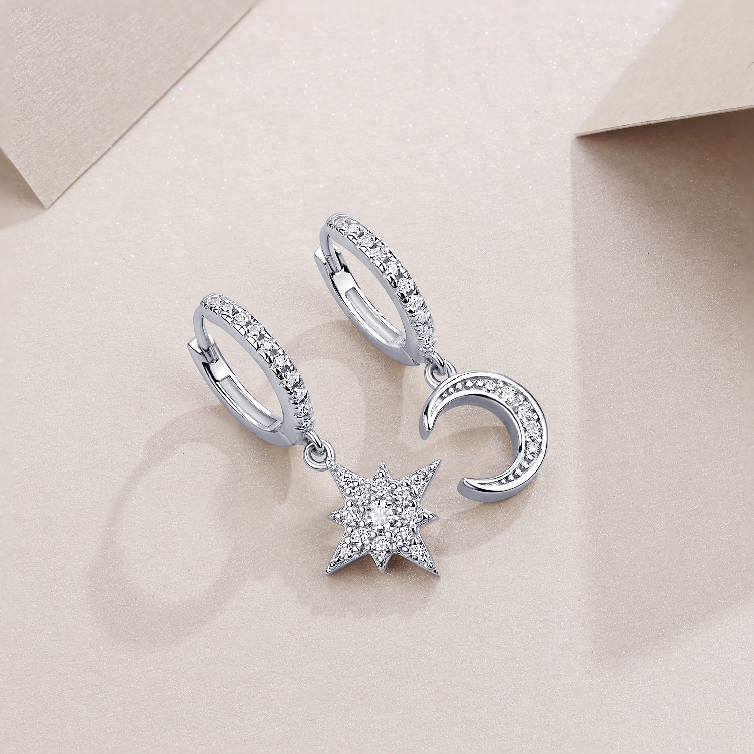 Asymmetric moon & star drop earrings with pavé halos, white gold vermeil finish